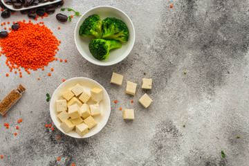 Fototapeta na wymiar tofu (soy cheese) and a set of ingredients healthy food - superfood. copy space. food background. top