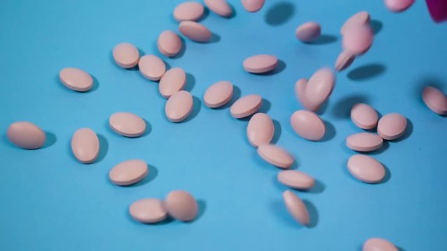 tablets fall on a blue background and roll