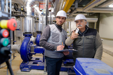 two male workers in industrial workplace