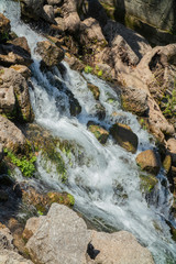 the raging flow of a mountain river like a waterfall in the forest