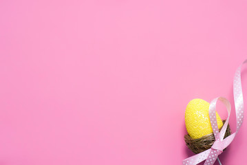 Easter composition with colorful egg on pink background, space for text. Funny decoration. Happy Easter