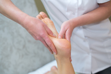 closeup of foot massage in spa salon