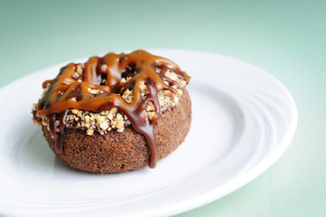 Donut Coated with Chocolate, Caramel and Nuts - Unhealthy Breakfast Eating
