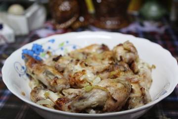 chicken fried with onions on a plate close-up