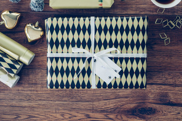 Wrapped Christmas present on wood, top view