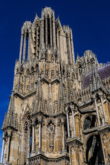 Fototapeta premium Architectural fragments of Reims Notre-Dame cathedral. Notre-Dame de Reims Cathedral (Our Lady of Reims, 1275) is Roman Catholic Church in Reims. Champagne-ardenne, France.