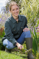 smiling blond woman gardening