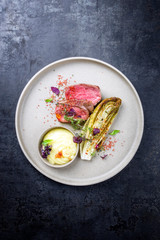 Barbecue wagyu point steak from beef sliced with chicory and mashed potatoes as top view on a modern design plate with copy space