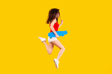 Fototapeta na wymiar girl with blue skateboard jumping on a yellow background, concept of summer hobbies