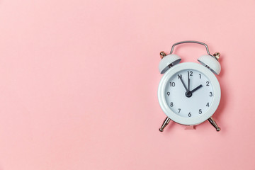 Ringing twin bell vintage classic alarm clock Isolated on pink pastel colorful trendy background....