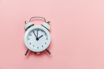 Ringing twin bell vintage classic alarm clock Isolated on pink pastel colorful trendy background....