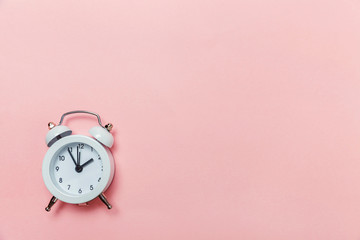 Ringing twin bell vintage classic alarm clock Isolated on pink pastel colorful trendy background....