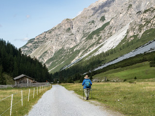 Fototapeta na wymiar HIker in the mountain landscape of the Pinnistal, a valley that branches off from the Stubai valley, Stubai Alps, Tyrol, Austria, Europe