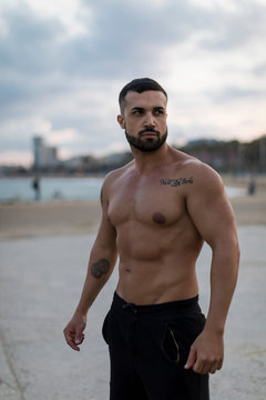 Portrait of bare chested muscular man outdoors