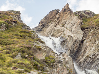 Fototapeta premium Mountain waterfall near the Dresdenerhutte at the end of the Stubai Valley (Stubaital), Alps, Tyrol, Austria, Europe