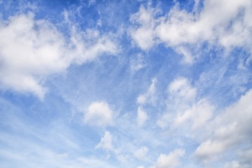 Blue sky with cirro cumulus and puffy white clouds. Sky background