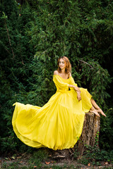 Obraz na płótnie Canvas Incredibly beautiful girl in a yellow long dress! The unity of nature and man. Spring and summer mood in a yellow dress!