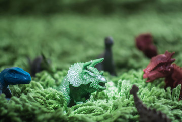 Toy dinosaurs in high grass miniature wild life