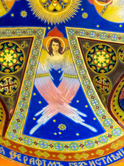 Colorful fresco with angel and ornaments painted by artist J. Bucmaniuk on the ceiling of a chapel...