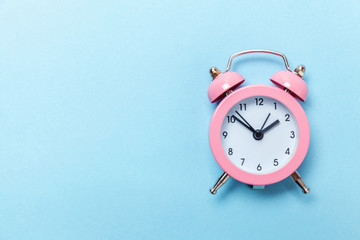Ringing twin bell vintage classic alarm clock Isolated on blue pastel colorful trendy background....