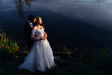 the bride in a beautiful dress with a lace closed her eyes and g