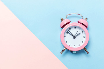 Ringing twin bell vintage classic alarm clock Isolated on blue pink pastel colorful trendy...