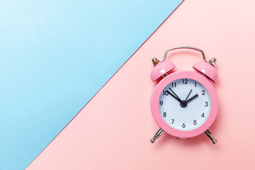 Ringing twin bell vintage classic alarm clock Isolated on blue pink pastel colorful trendy...