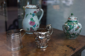 Silver mug with face in it.