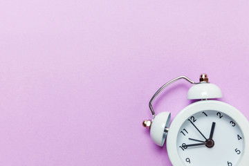 Ringing twin bell vintage classic alarm clock Isolated on purple violet pastel colourful...
