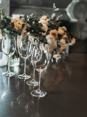 Glasses on the table. Bunch of clear champagne glasses. Festive table setting. Wedding decor. Table setting in fine art style. Table decor.