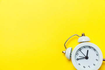 Ringing twin bell vintage classic alarm clock Isolated on yellow colourful trendy modern...