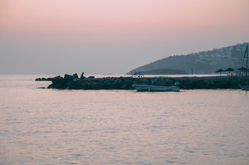 Obraz premium Enjoying life. Young man resting at sunset, looking at the sea, relaxing lifestyle concept