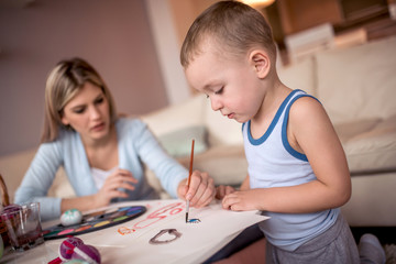 Mother and little boy painting