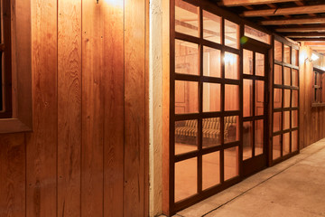 wooden room seen from the outside in the night with lights on