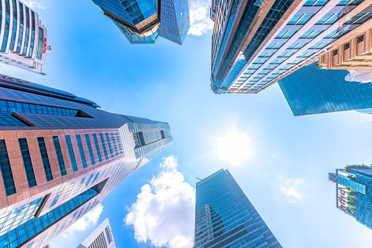 Singapore, High rise buildings, low angle view against the sun