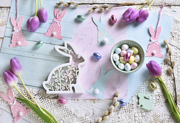 pastel color easter flat lay with tulips eggs and bunnies