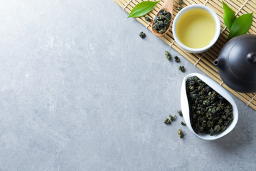 Flat lay composition with cup of Tie Guan Yin oolong tea and space for text on grey background - obrazy, fototapety, plakaty