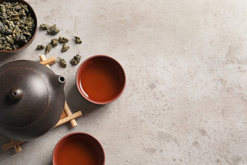 Flat lay composition with cups of Tie Guan Yin oolong tea and space for text on table - obrazy, fototapety, plakaty