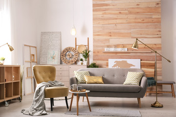 Stylish living room interior with comfortable sofa. Idea for home decor