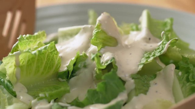 Camera follows tossing salad with dressing. Shot with high speed camera, phantom flex 4K. Slow Motion.
