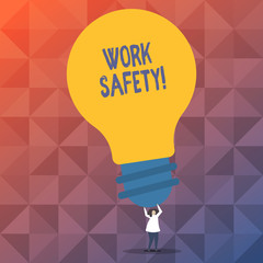 Handwriting text writing Work Safety. Conceptual photo policies and procedures in place to ensure health of employees Person Standing and Raising Up Arms Holding Big Yellow Lightbulb for Ideas