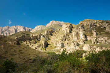 Fototapeta na wymiar Mountains and the nature of the North Caucasus, the blue sky over high rocks in the beautiful gorge