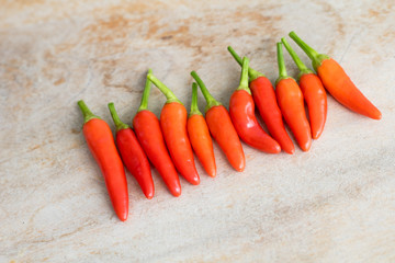 Red hot chili peppers on old wooden table.