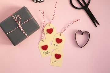 Valentine gift and self-made tags on pink background