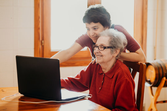 Granddaughter Teaching Her Grandmother How To Use A Computer