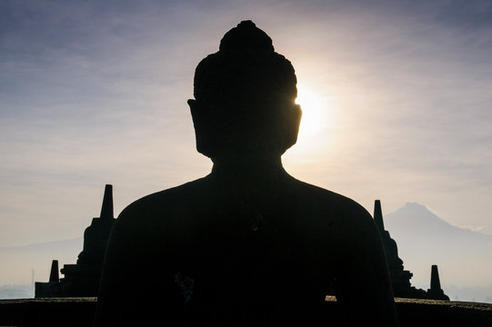Indonesia, Java, Borobudur Temple Complex, sitting Buddha in backlight