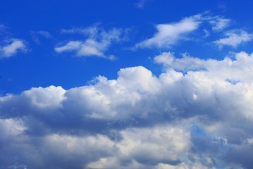 Naklejka na ściany i meble many white gray clouds on a daytime blue sky