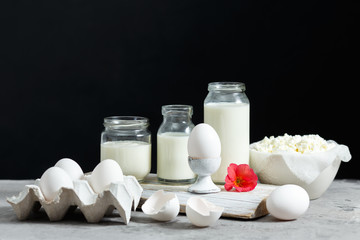 Fresh dairy and fermented milk products. Eggs On a black background.