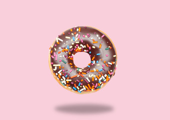 Chocolate donut on pastel pink background.