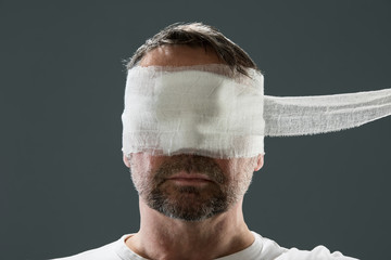 Man with gauze bandage, beauty craze